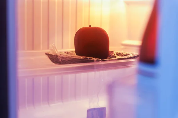 Red apple in fridge, cold storage, Selective focus