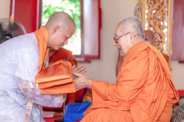 Bangkok, Tayland - 27 Mart 2021: Genç bir adam rahiplik görevine atanmak için hocasına bir papazlık töreni düzenliyor.