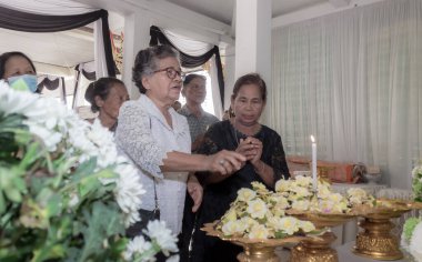 Phatthalung, Tayland - 05 Nisan 2024: İnsanlar yakma töreninde yas tutmak için çiçek bırakıyor