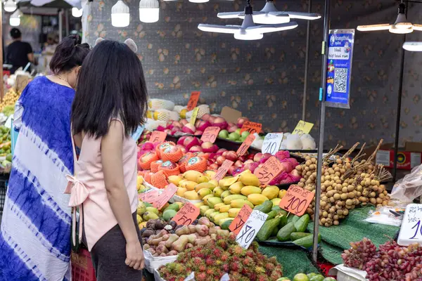 stock image Suratthani, Thailand- April 21, 2024: People walking on the streets to buy food and fruits, vegetable, that is sold along the roadside both in the city and rural areas of Thailand, Street food