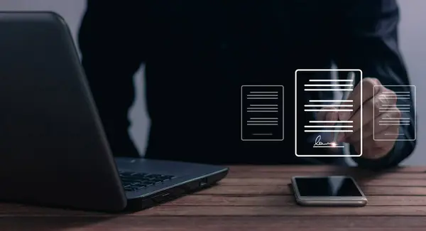 stock image Young man uses a smartphone and computer to sign a business contract online, Oline business contract, Electronic signature, Digital documents, Future business contract signing