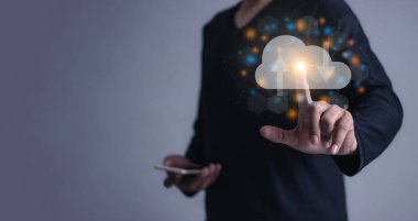 Akıllı cep telefonlu genç adam bulut hesaplama diyagramına, veri depolamasına, bulut teknolojisine, bulut depolama deposuna dokunuyor.