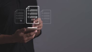 Akıllı cep telefonu olan genç bir adam internet üzerinden iş sözleşmesi imzalamak için kalem kullanıyordu. Elektronik imza, kontrat imzalama, dijital belgeler, gelecekteki akıllı sözleşmeler.