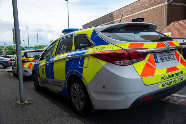 stock image View of police emblems in Ireland, emblem on building, car, and street lantern, Limerick,Ireland,11,06,2023