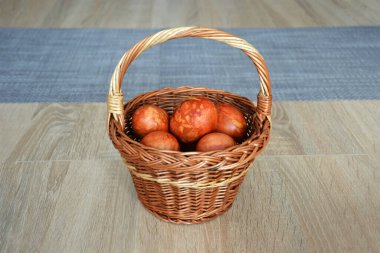 Easter eggs in the basket. Easter egg dyed with onion peel. Happy Easter concept.