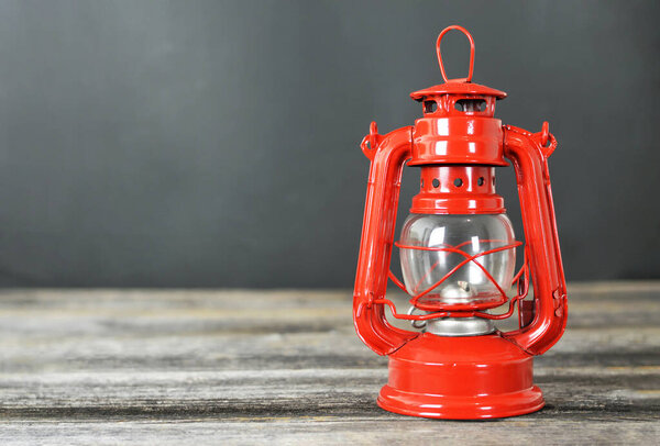 Vintage oil lamp on wooden background with copy space