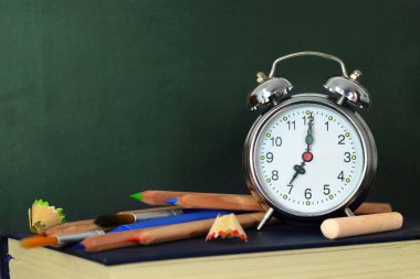 Okul geçmişine, boş tahta, okul gereçleri ve çalar saatle döndüm.            