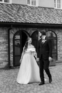 young couple bride and groom in a white dress walking