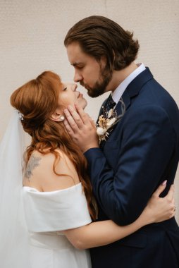 young couple bride and groom in a white dress walking