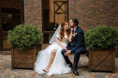 young couple bride and groom in a white dress walking