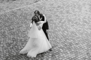 young couple bride and groom in a white dress walking