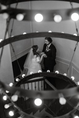 young couple bride and groom in a white dress walking