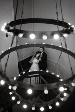 young couple bride and groom in a white dress walking