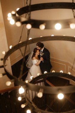 young couple bride and groom in a white dress walking