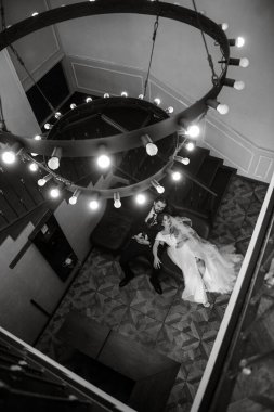 young couple bride and groom in a white dress walking