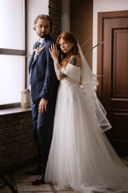 young couple bride and groom in a white dress walking