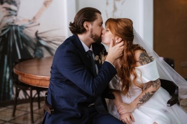 young couple bride and groom in a white dress walking
