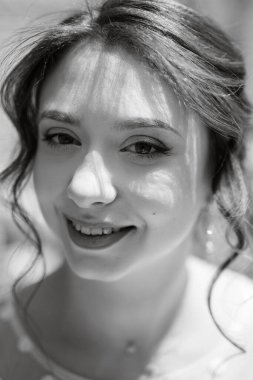 portrait of a young bride girl in a light dress walks in an urban environment