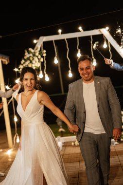 newlyweds at a wedding in the corridor of sparklers