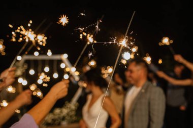 newlyweds at a wedding in the corridor of sparklers