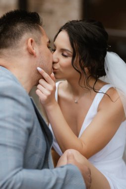 young couple the groom in a blue suit and the bride in a white dress on a walk