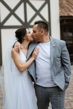 young couple the groom in a blue suit and the bride in a white dress on a walk