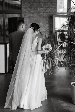 young couple the groom in a blue suit and the bride in a white dress on a walk