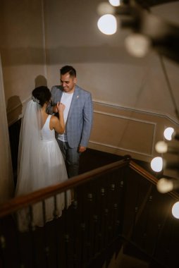 young couple the groom in a blue suit and the bride in a white dress on a walk