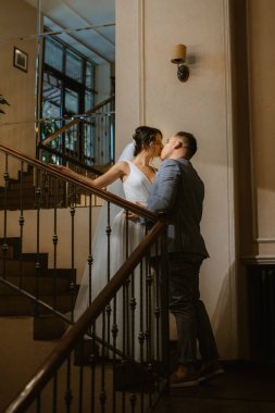 young couple the groom in a blue suit and the bride in a white dress on a walk