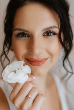 preparations for the bride with the dressing of the wedding dress in the studio