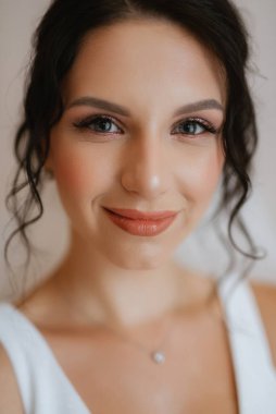 preparations for the bride with the dressing of the wedding dress in the studio