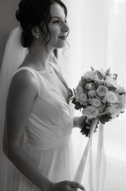 preparations for the bride with the dressing of the wedding dress in the studio