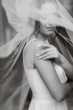 preparations for the bride with the dressing of the wedding dress in the studio