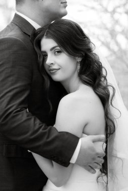 the groom and the bride are walking in the forest on a bright day