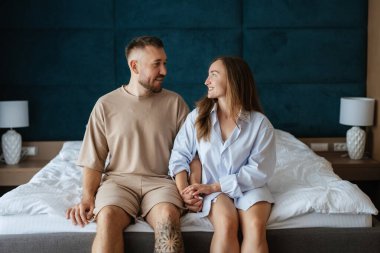 earlier morning bride and groom at home in bed