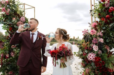 wedding ceremony of the newlyweds on the pier near the restaurant