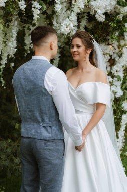 wedding ceremony of the newlyweds on the glade near the restaurant