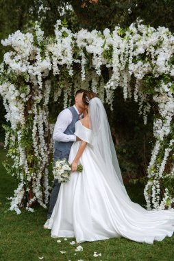 wedding ceremony of the newlyweds on the glade near the restaurant