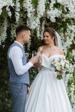 wedding ceremony of the newlyweds on the glade near the restaurant