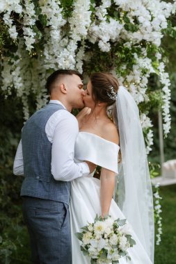 wedding ceremony of the newlyweds on the glade near the restaurant