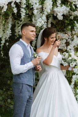 wedding ceremony of the newlyweds on the glade near the restaurant