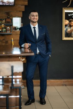 portrait of a bearded groom guy in a dark blue suit