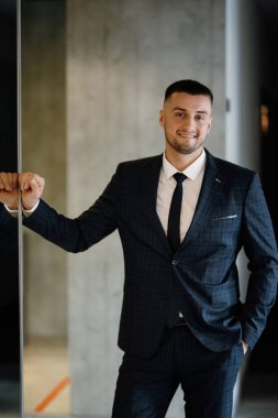 portrait of a bearded groom guy in a dark blue suit
