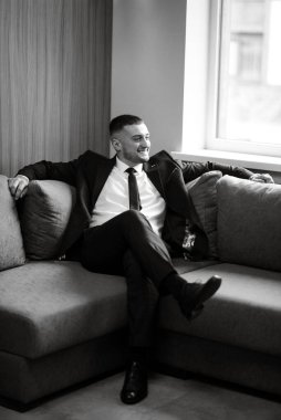 portrait of a bearded groom guy in a dark blue suit