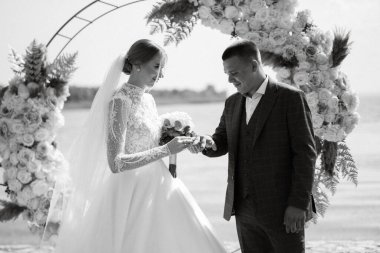 wedding ceremony of the newlyweds on the pier near the restaurant