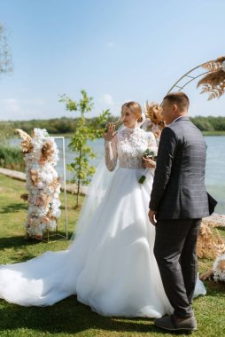wedding ceremony of the newlyweds on the pier near the restaurant