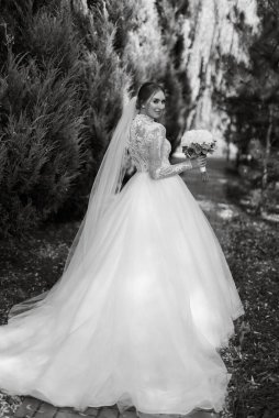 portrait of a bride in the morning before the wedding with putting on a white dress
