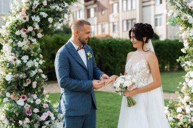 wedding ceremony of the newlyweds on the glade near the restaurant