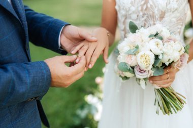 wedding ceremony of the newlyweds on the glade near the restaurant