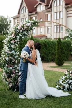 wedding ceremony of the newlyweds on the glade near the restaurant